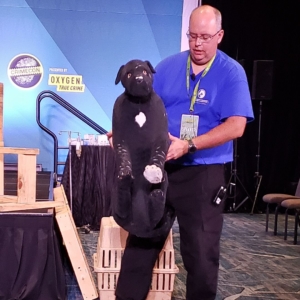 crime con dog fighting: Adam Stern holding up his dog model Clifford for people to see anterior injuries typical of front-facing fighting