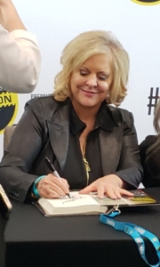 Nancy Grace signing books at table