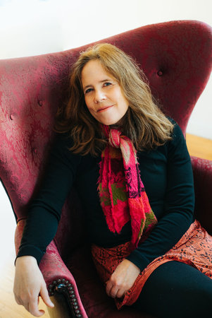 Pagan Kennedy author photo (woman sitting in a winged-back chair) by Adrianne Mathiowetz