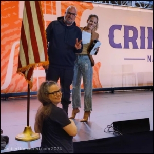After the interview, Anthony Zuiker and Stephanie Bauer with Amber Love on the floor looking at the camera.