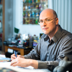 Alex Ross at a drawing desk
