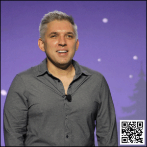 Brian Entin smiling as he introduces himself and the subject to the audience before his guests come on stage.