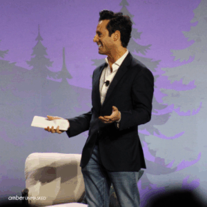 Jesse Weber smiling on the stage at CrimeCon